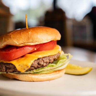 A close up of the Big George cheeseburger with American cheese, lettuce and tomato.