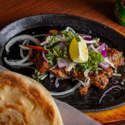 Beef Seekh Kebab and naan bread on the side.