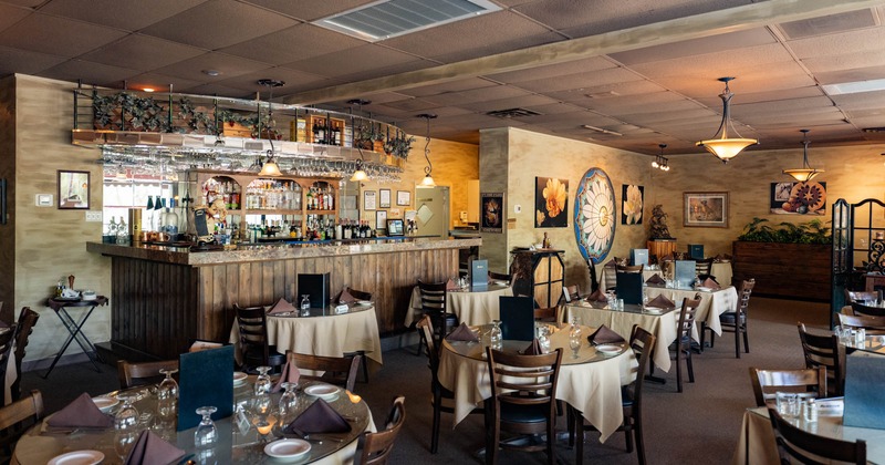 Interior, dining area, tables ready for guests, bar, carpet flooring