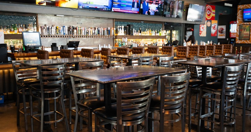 Interior, seating area with bar tables and bar stools