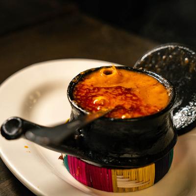 Chickpea stew served in a small clay pot.