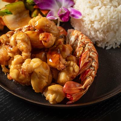 Hibachi lobster with rice and vegetables, close up.