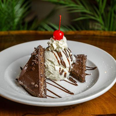 Chocolate Fudge Brownie Sundae served on a white plate.