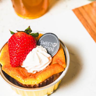 Mini Basque Cheesecake, with strawberry and whipped cream.