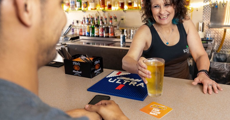 A bartender serving a customer