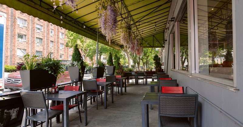 Exterior, covered seating area,  tables for two, hanging flower pots as a decoration