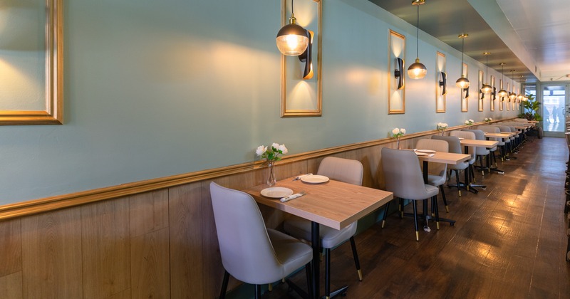 Diner tables and armchairs by wall