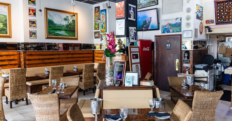 Interior, tables ready for guests, pictures on the walls