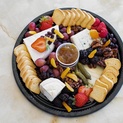 Appetizer platter, with bread, cheese, fruits, and nuts