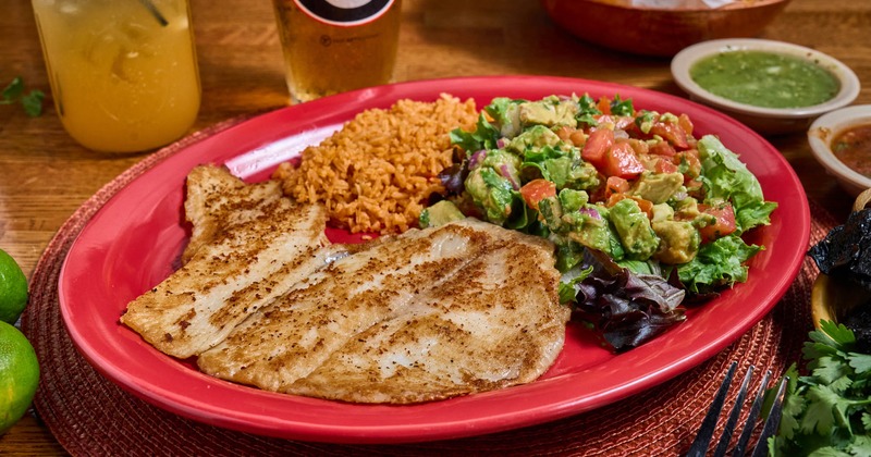 Grilled tilapia, served with rice, and chunky guacamole