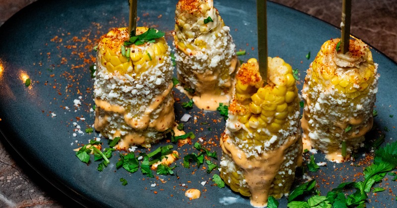 Mexican Street Corn with crema, crumbled Cotija cheese and chili powder