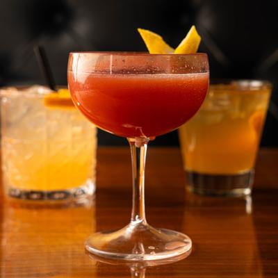 Jack Rose cocktail served in a coupe with lemon peel garnish.