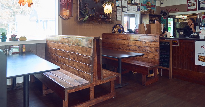 Dining area with wooden booths and an order counter