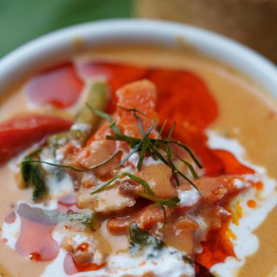 Panang Curry with coconut milk, peanuts, basil and bell peppers, close-up.