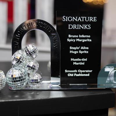 Tiny mirror ball ornaments, metal arch, and a cocktail menu.
