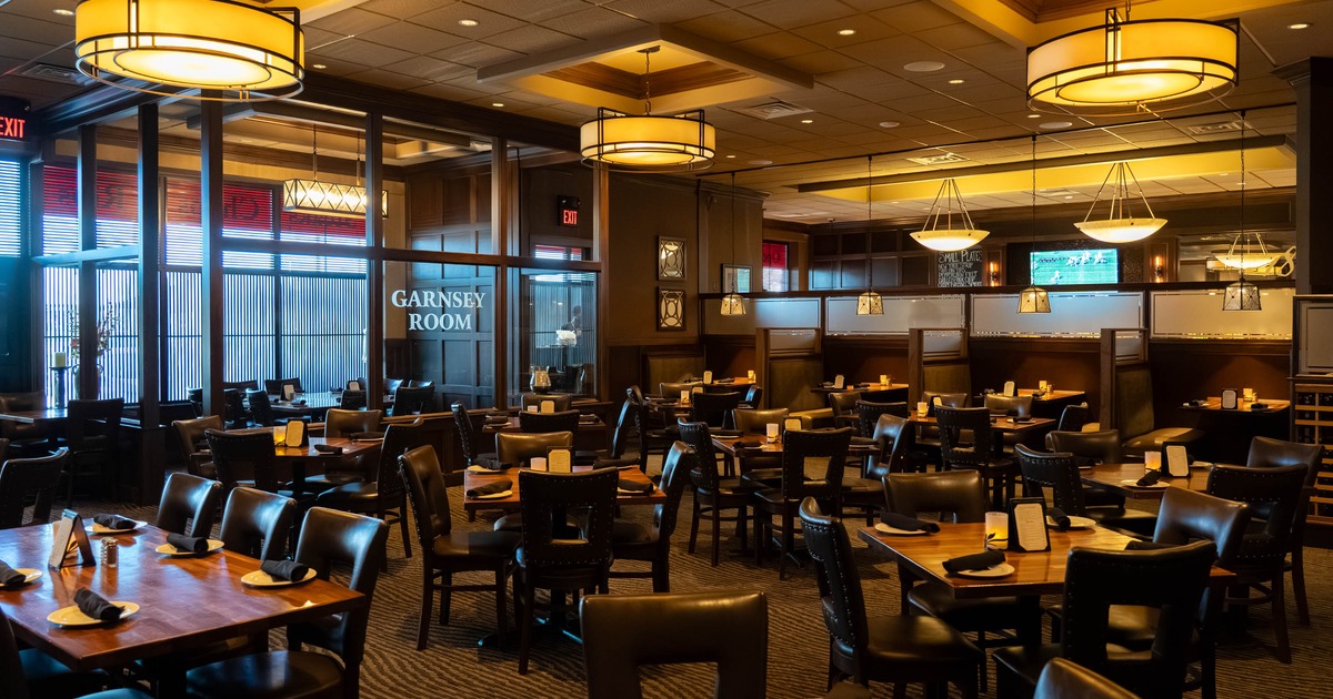 Interior, open space dining area, tables ready for guests, restaurant entrance