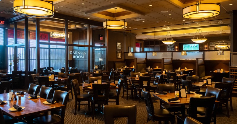 Interior, open space dining area, tables ready for guests, restaurant entrance