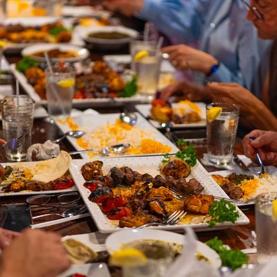 Group enjoying a Mediterranean feast at a restaurant.