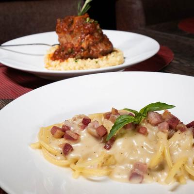 Veal shank on risotto plate and pasta with Pecorino truffle sauce and smoked speck ham.