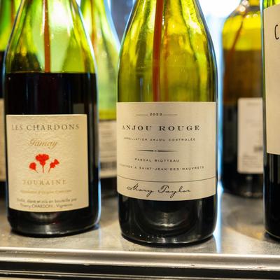 Assorted red wine bottles in a dispenser machine.