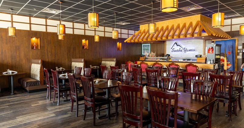 Interior, dining tables and inline booths near the sushi bar, angle view