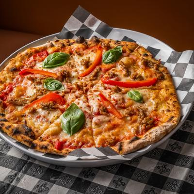 The Port Pie topped with sausage, bell peppers, and fresh basil.