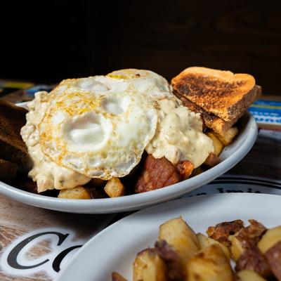 Hangover Bowl, with fried eggs, toast, deep fried home fries, bacon, sausage gravy, and toast.