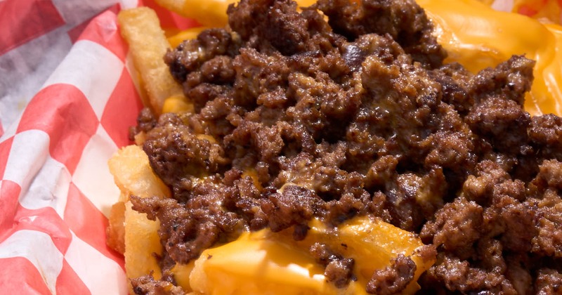 Close-up of fries topped with melted cheese and seasoned ground beef