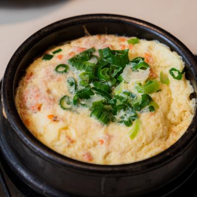 A traditional Korean steamed egg dish, served in a black pot.