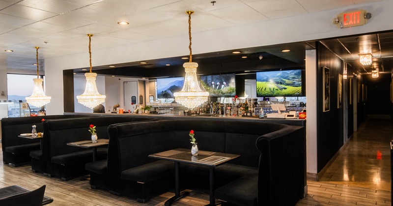 Modern and cozy interior seating area with black upholstered booths