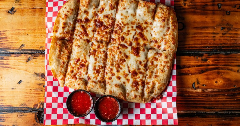 Cheese bread sticks served with a tomato sauce