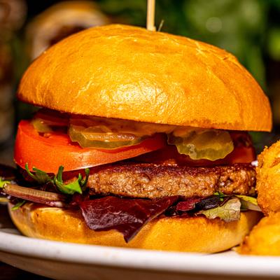 Impossible burger with lettuce. pickles and tomato, close-up.