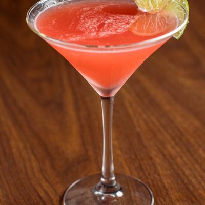 Cosmopolitan cocktail with lime garnish.