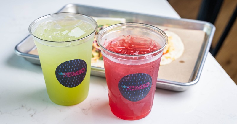 Green and red iced drinks in clear cups