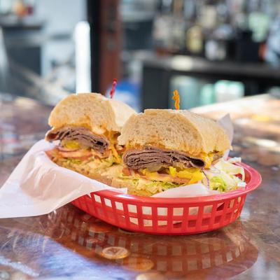 The Backwards Burger sandwich with hot roast beef, cheddar, lettuce, and tomatoes.