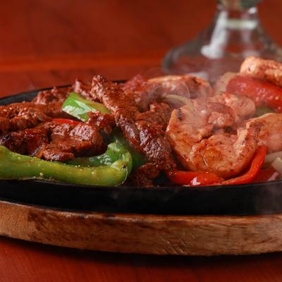 Mixed fajita emitting steam, close up