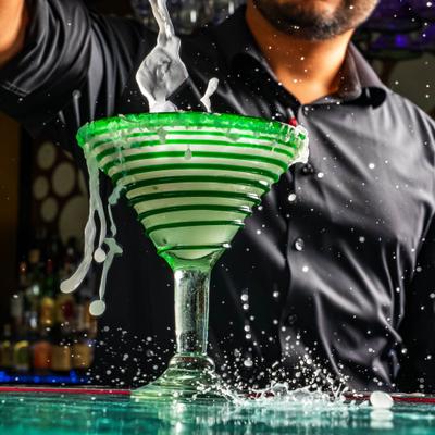 A person preparing a martini.