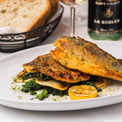 Roasted branzino with broccoli rabe and cottage fries.