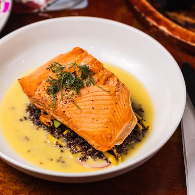 Pan Seared Salmon with quinoa, mango avocado salad, and beurre blanc sauce.