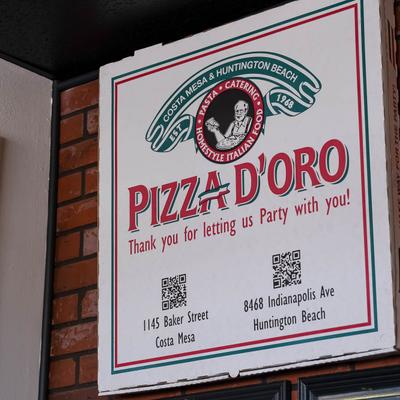 The restaurant's name on the board hanging on the wall.