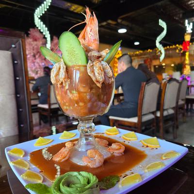 A seafood cocktail, served on a table in the lively dining area.