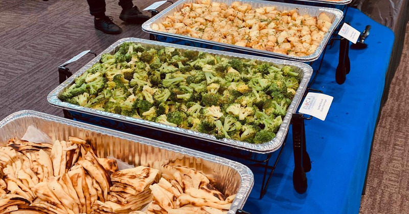Broccoli and other food displayed on a buffet table