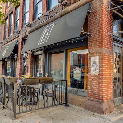 Exterior, seating area, tables by the front entrance.
