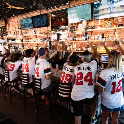 Large group of people seated at the bar, celebrating an event.