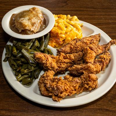 Crispy fried chicken served with green beans and macaroni and cheese.