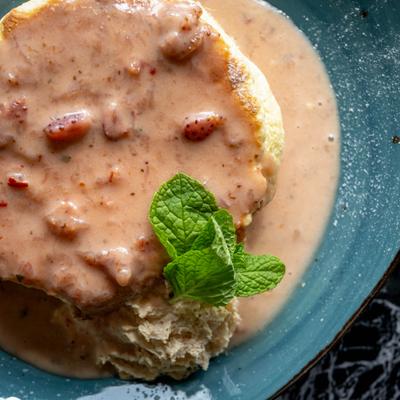 Souffle pancake topped with creamy sauce and mint.