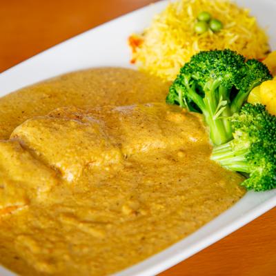 Salmon in Malai cream, served with rice, and veggies.