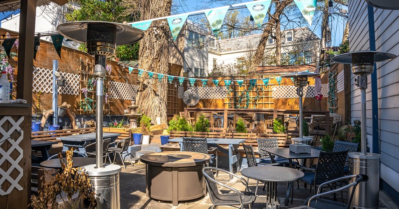 Patio, seating area with tables and chairs and heaters