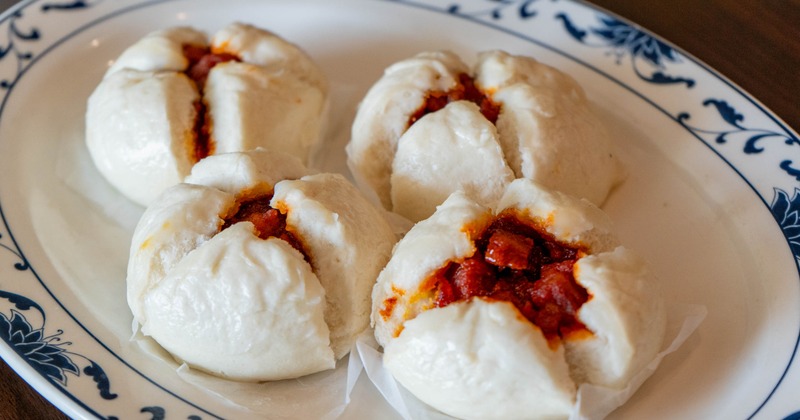 Steamed buns filled with barbecue pork and served on the plate