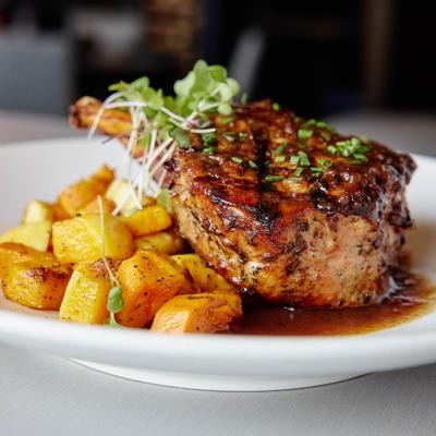 Grilled double cut pork chop, front view, closeup.